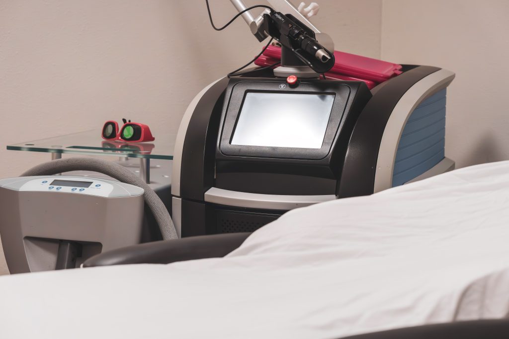 Medical-grade laser machine in a treatment room.